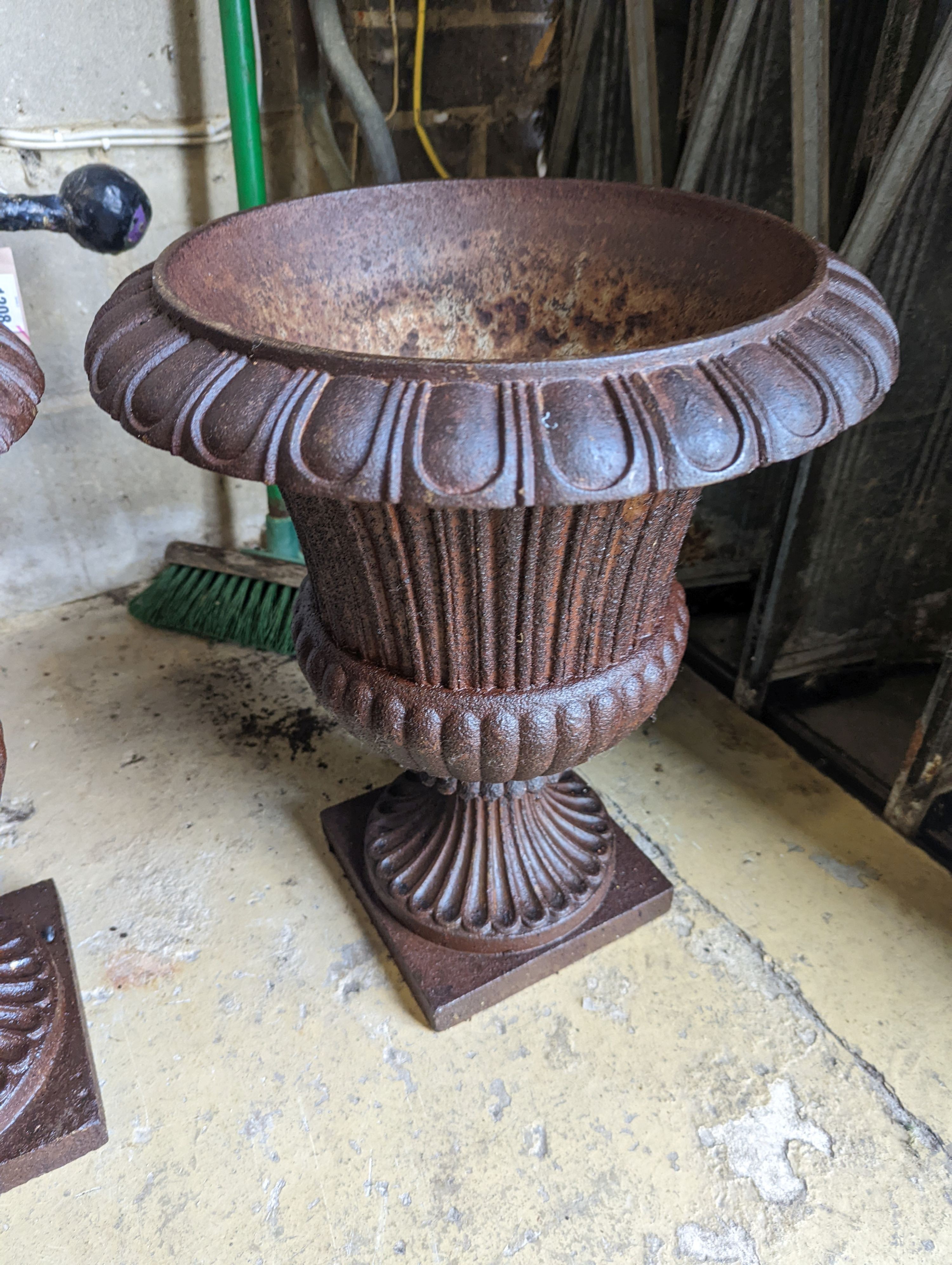 A pair of Victorian circular cast iron campana garden urns, diameter 38cm, height 46cm